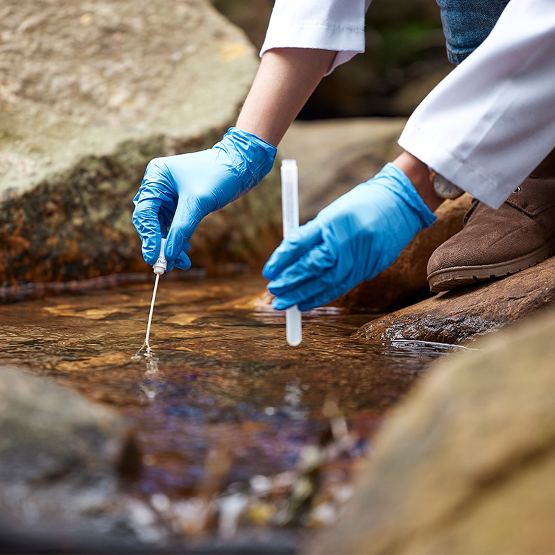 scientist collecting environmental water field sample